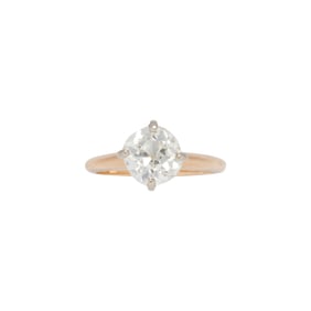 A diamond and 14k bi-color gold solitaire ring