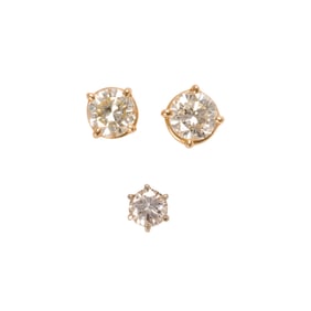 A pair and a single diamond and 14k gold solitaire earrings
