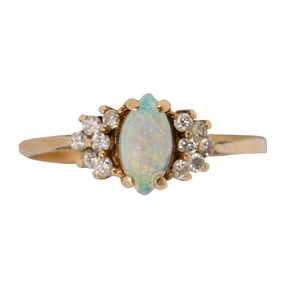 An opal, diamond, and high karat gold ring
