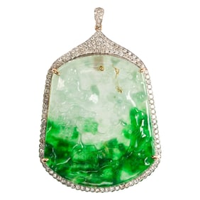 A carved jade, diamond, and 14k gold pendant