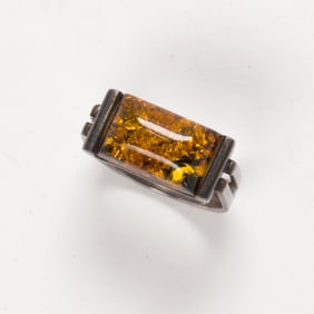 An amber and silver ring