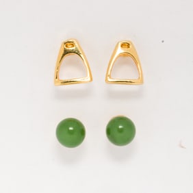 A group of two gold plated stud earrings