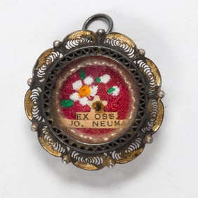 A silver cased reliquary pendant of Saint John Neumann