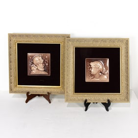 A pair of framed majolica tiles depicting Neoclassical profiles