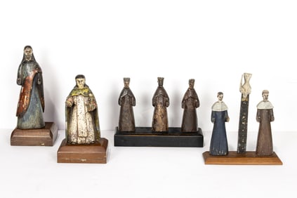 A group of seven Puerto Rican polychrome wood Santos figures on four stands