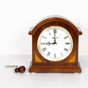 A Churchill mantel clock and a pair of brass bookends, Senator Feinstein Estate