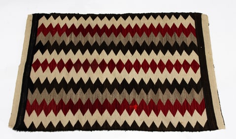 A Navajo Dine rug with lightning bands, 32
