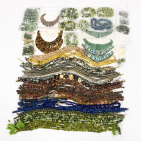 A group of stone beads, including lapis, hardstone, jade, mother of pearl, abalone and metallic