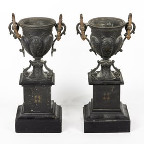 A pair of Victorian patinated metal mantel urns