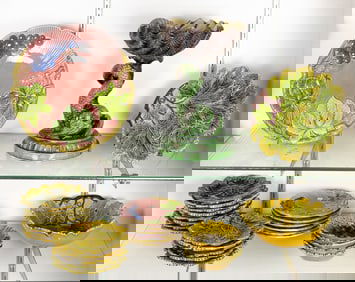 Twenty eight pieces of majolica, comprising dolphin pedestal dish and Czechoslovakian leaf molded