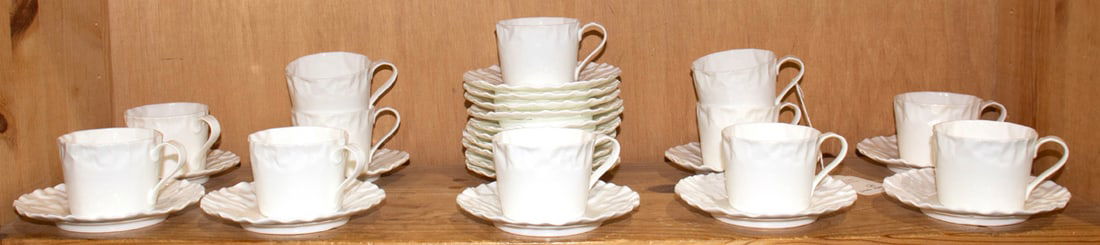 A group of Japanese porcelain cups and saucers in the Crinkle pattern: A group of Japanese porcelain cups and saucers in the Crinkle pattern, designed by Makoto Komatsu, comprising (12) tea cups, 2.5"h and (19) saucers, 5 5/8"dia [31 total]