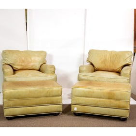 A pair of Lackwana leather club chairs with matching ottomans
