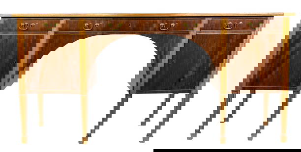 A Frits Henningsen mahogany sideboard in the Sheraton taste: A Frits Henningsen mahogany sideboard in the Sheraton taste, circa 1940, the bowed front fitted with three drawers and two doors, includes key, 35.5?h x 74.75?w x 23.5?d
