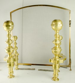 A pair of Baroque style bronze andirons with a firescreen