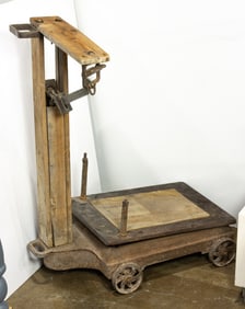 An Industrial wood and iron scale on casters