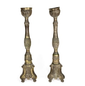 A tall pair of Continental Baroque style repousse brass candle prickets