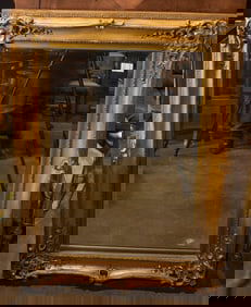 A large Rococo style gilt framed beveled mirror