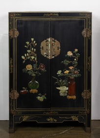 A Chinese black lacquered and hardstone inlaid cabinet