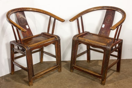 A pair of Chinese wood armchairs