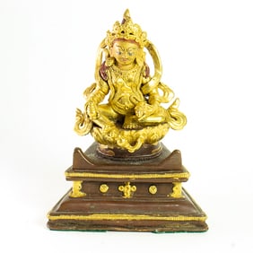 A Tibetan bronze figure of Jambhala