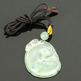 A Chinese green jadeite pendant