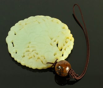 A Chinese white jade circular pendant