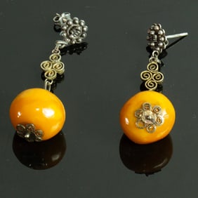 A pair of Chinese butterscotch amber and silver filigree ear clips