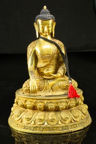 A Sino-Tibetan gilt bronze figure of the Medicine Buddha