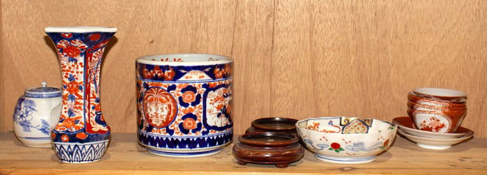 A shelf of Japanese porcelain articles