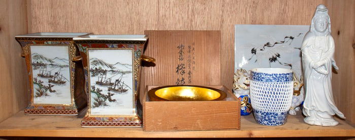 A shelf of Japanese ceramic items