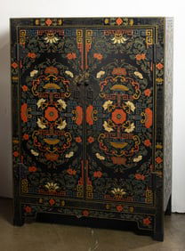 A Chinese black lacquered two door cabinet
