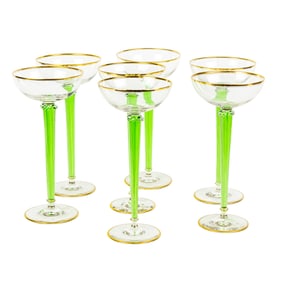 A set of seven French hand blown glass champagne flutes