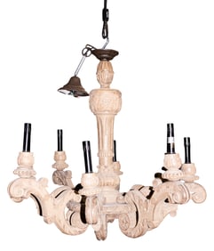 A Provincial style carved wood eight-light chandelier
