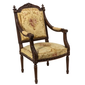 An assembled set of two Napoleon III tapestry upholstered carved wood armchairs