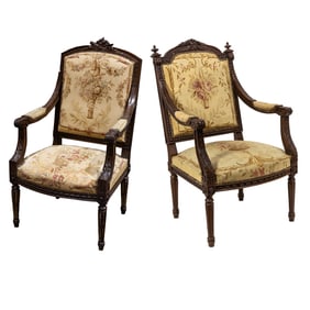 An assembled set of two Napoleon III tapestry upholstered carved wood armchairs