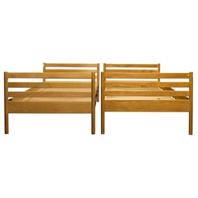 An assembled pair of Modern oak twin beds designed by Hans Wegner