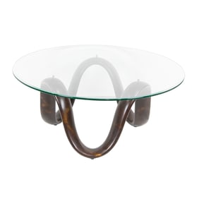 A contemporary glass and bronze finish cocktail table