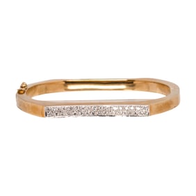 A diamond and 14k gold bangle bracelet