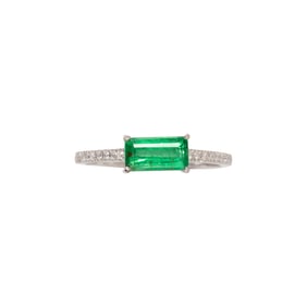 An emerald, diamond and 18k white gold ring