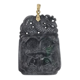 A charcoal jade and high karat gold pendant