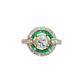 A diamond, emerald, and platinum ring