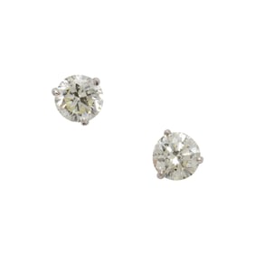 A pair of diamond and 18k white gold solitaire earrings