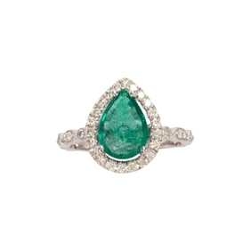 An emerald, diamond and 18k white gold ring