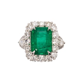 An emerald, diamond and platinum ring