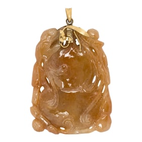 A red jade and 14k gold pendant