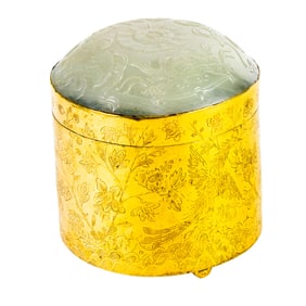 A Chinese gilt brass box with white jade cover