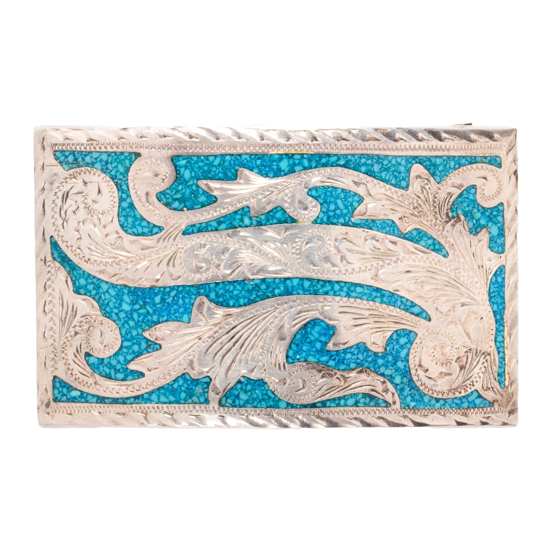 A composite turquoise and silver belt buckle: A composite turquoise and silver belt buckleFeaturing abstract silver etching, inlaid with composite turquoise; 3 1/8 in x 2 in; 46.30 grams