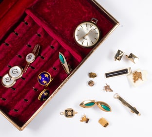 A box of vintage mens jewelry