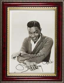 A framed photo of Nat King Cole, signed