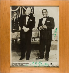 A Louis Armstrong signed Associated Booking Corp press photo of Bing Crosby and Louis Armstrong